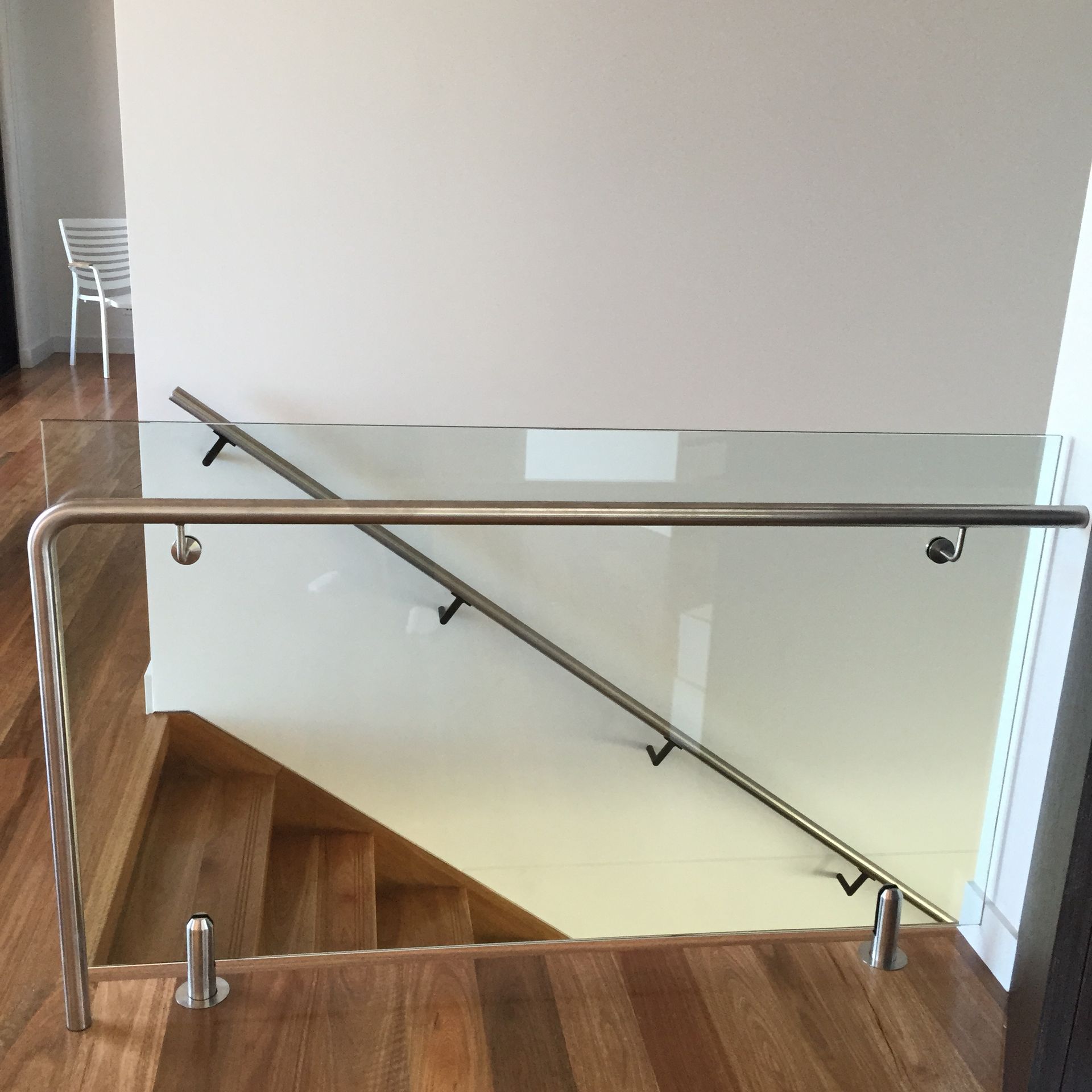 A staircase with a stainless steel railing and a glass railing — Fabricator In Coffs Harbour, NSW