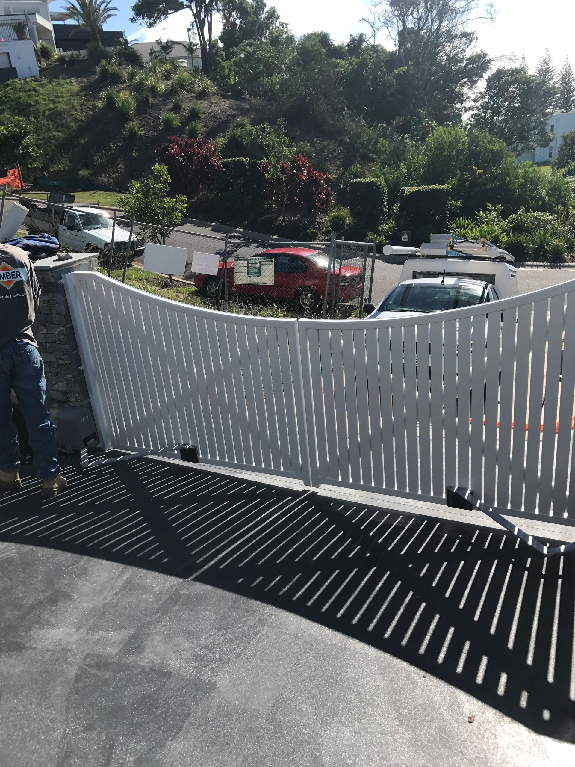 A white picket fence is being built in front of a house — Fabricator In Coffs Harbour, NSW