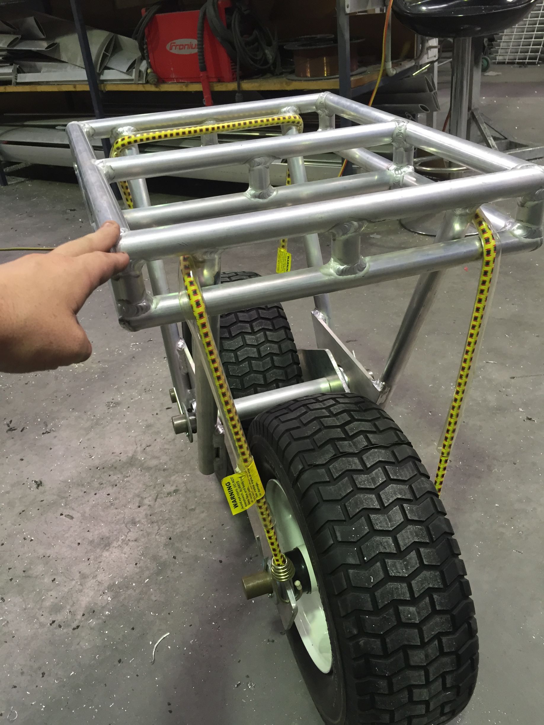 A person is measuring a wheelbarrow with a tape measure — Fabricator In Coffs Harbour, NSW