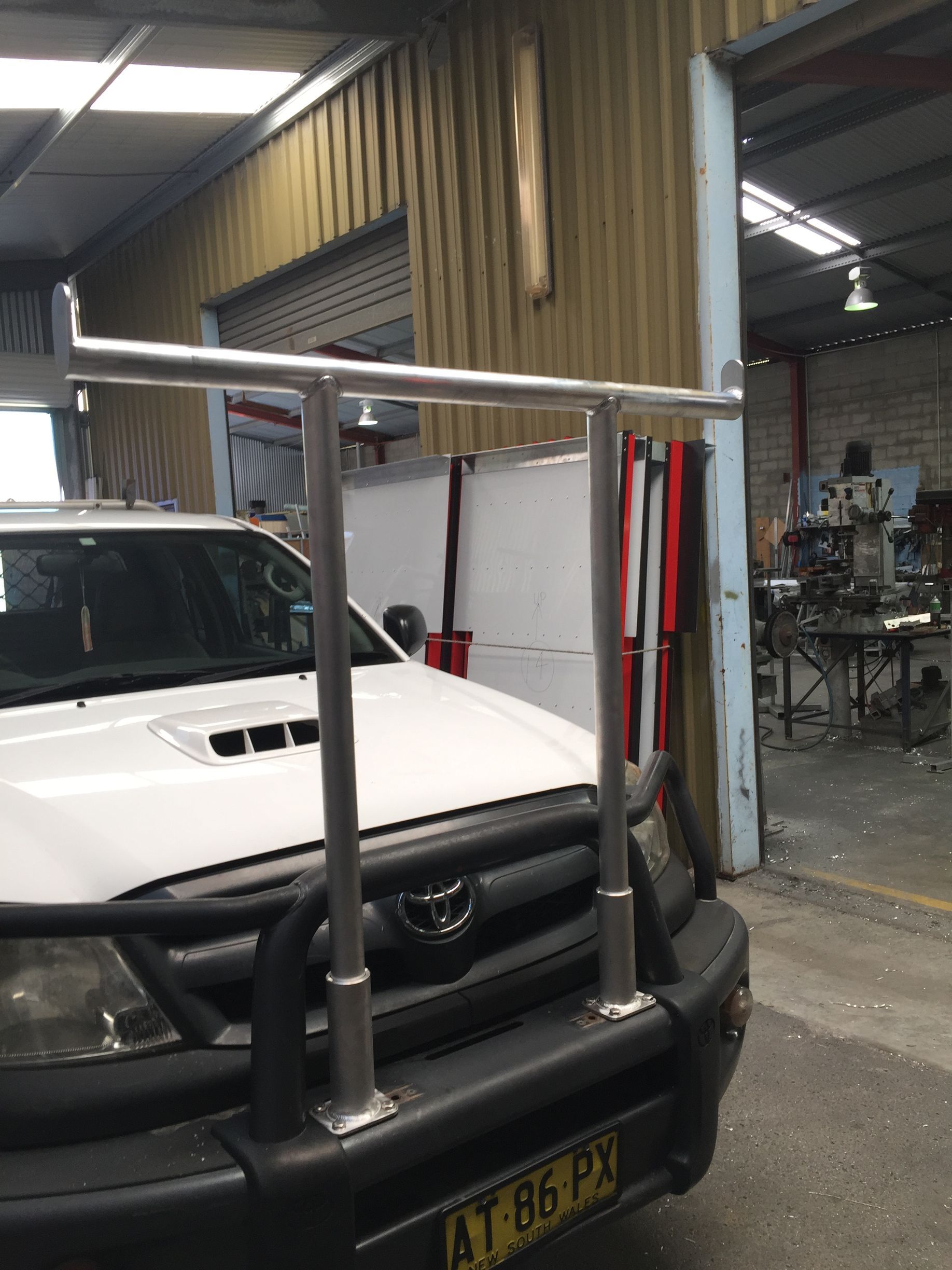 A white truck with a license plate that says at 86 p2 — Fabricator In Coffs Harbour, NSW