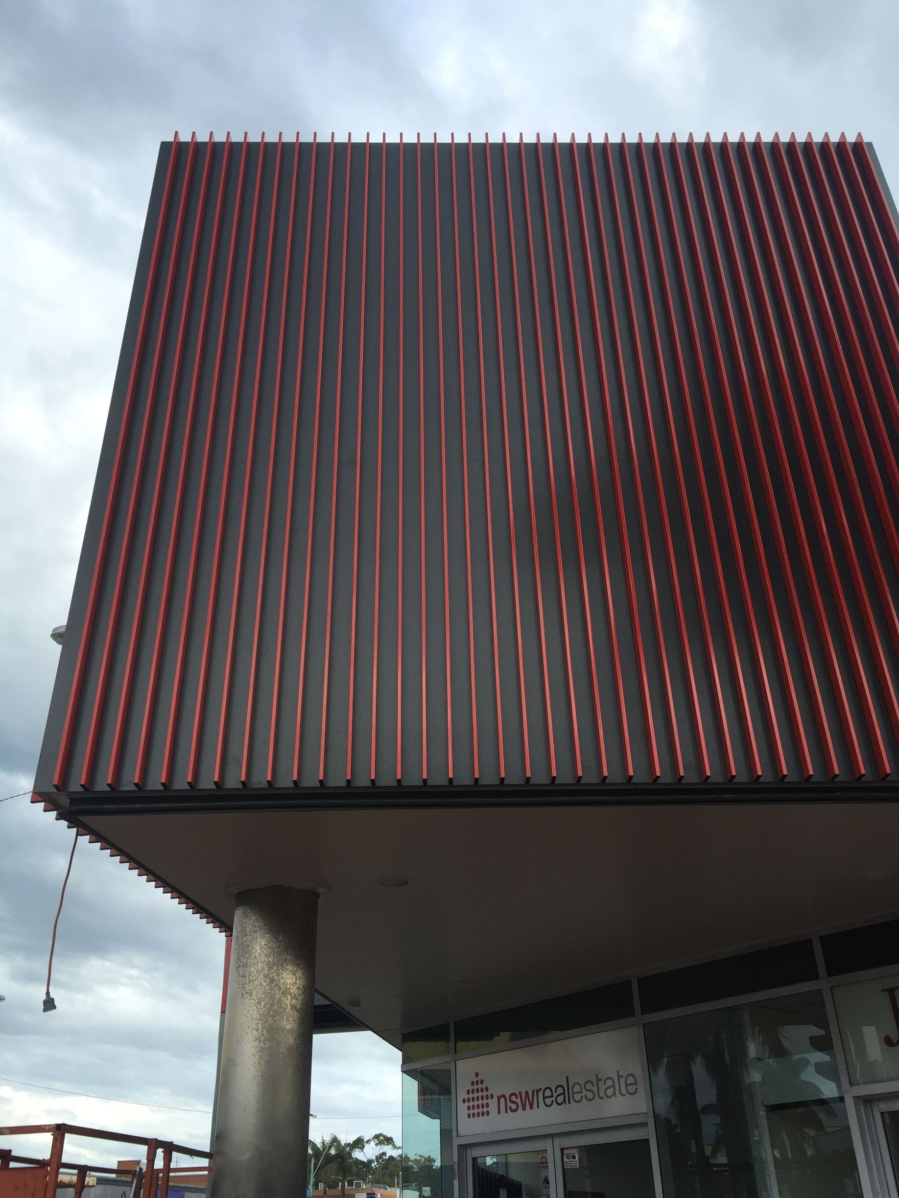 A building with a red roof and a sign that says ' a ' on it — Fabricator In Coffs Harbour, NSW