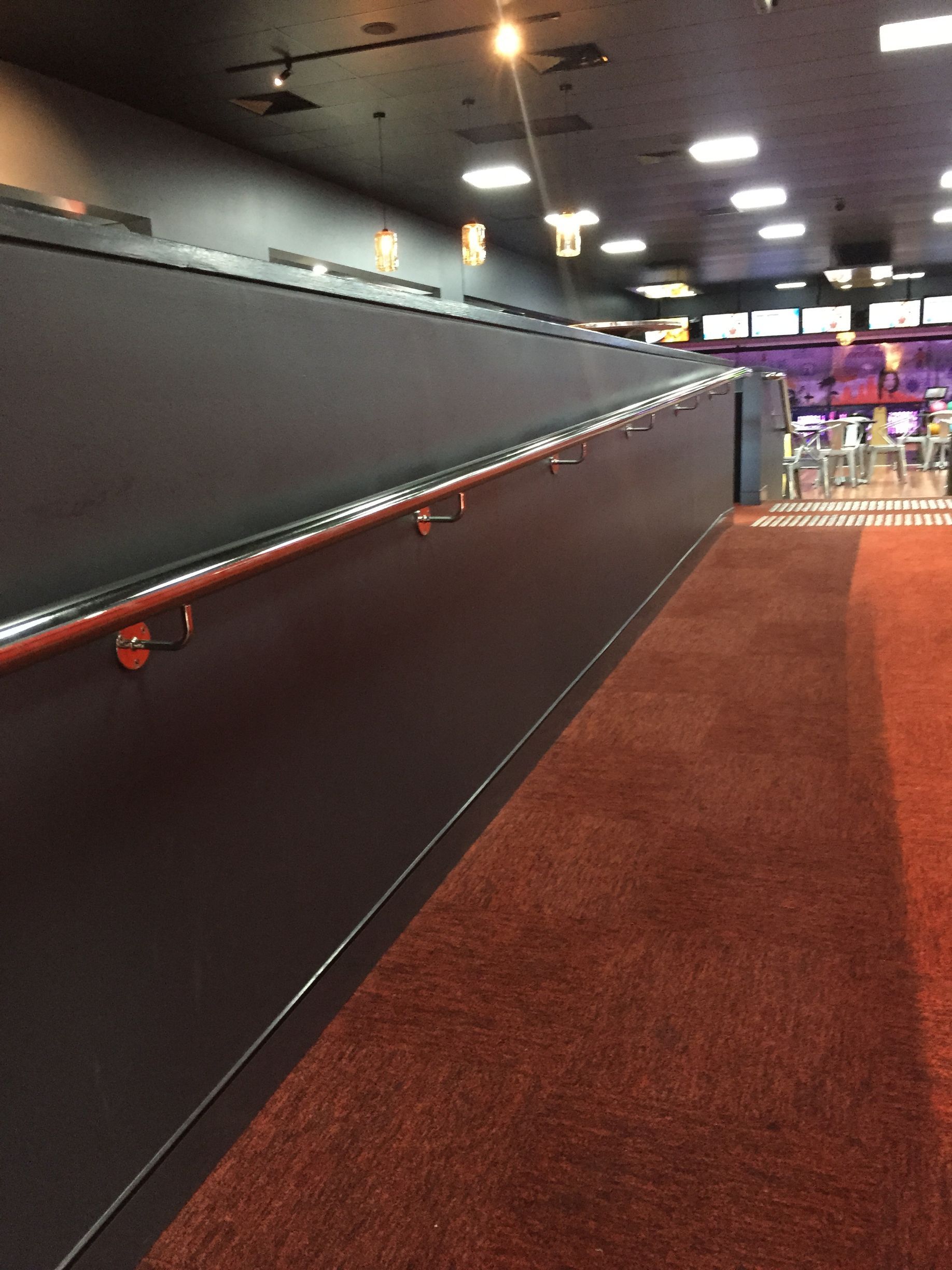 A long hallway with a red carpet and a black wall — Fabricator In Coffs Harbour, NSW