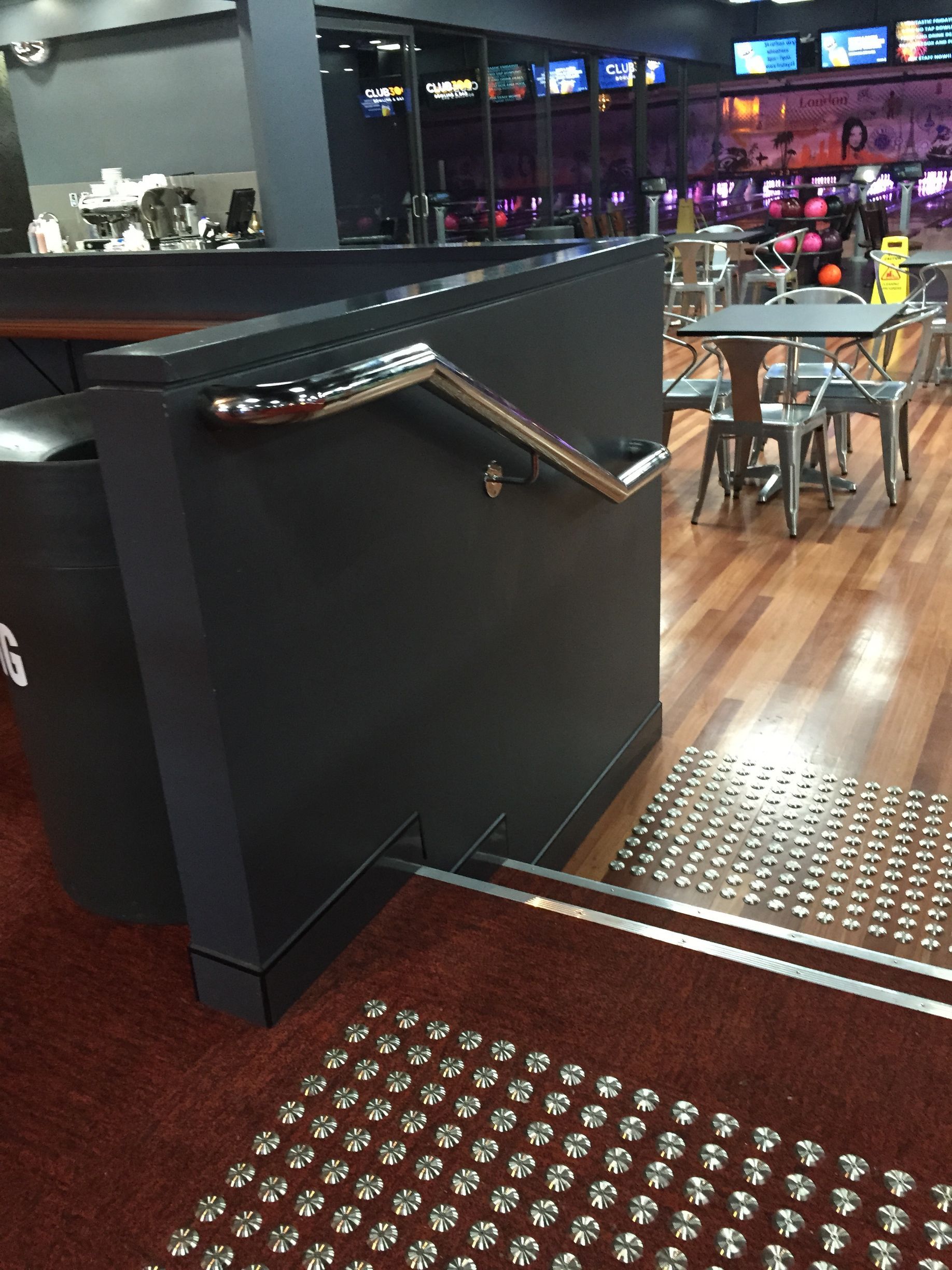 A staircase leading up to a bowling alley with tables and chairs — Fabricator In Coffs Harbour, NSW