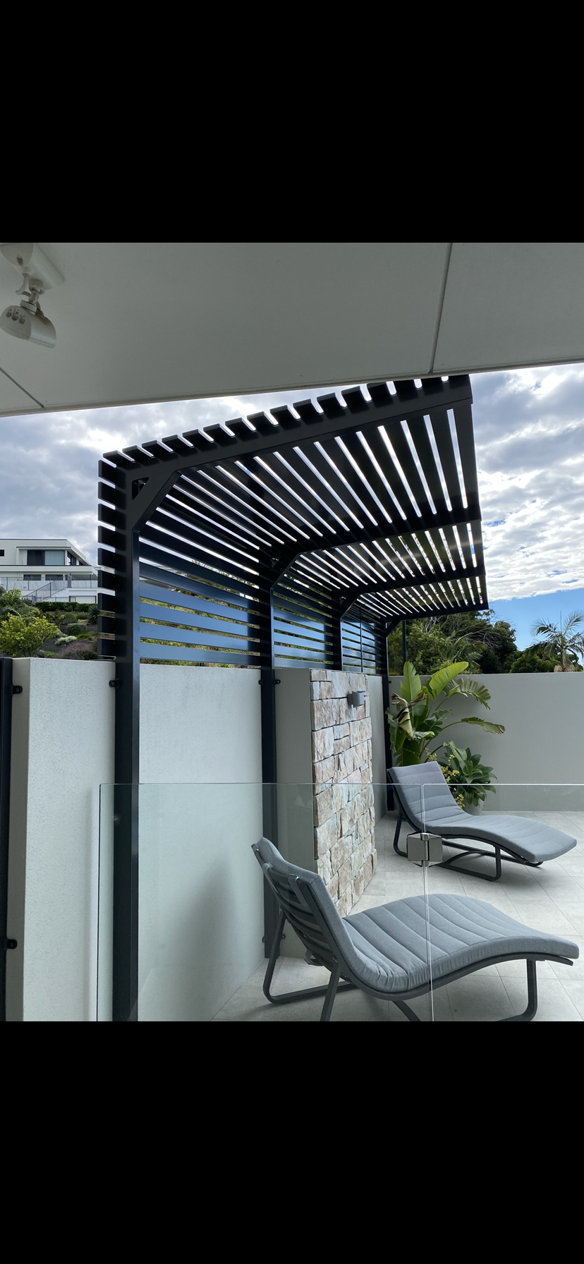 A patio with a pergola , lounge chairs and a shower — Fabricator In Coffs Harbour, NSW