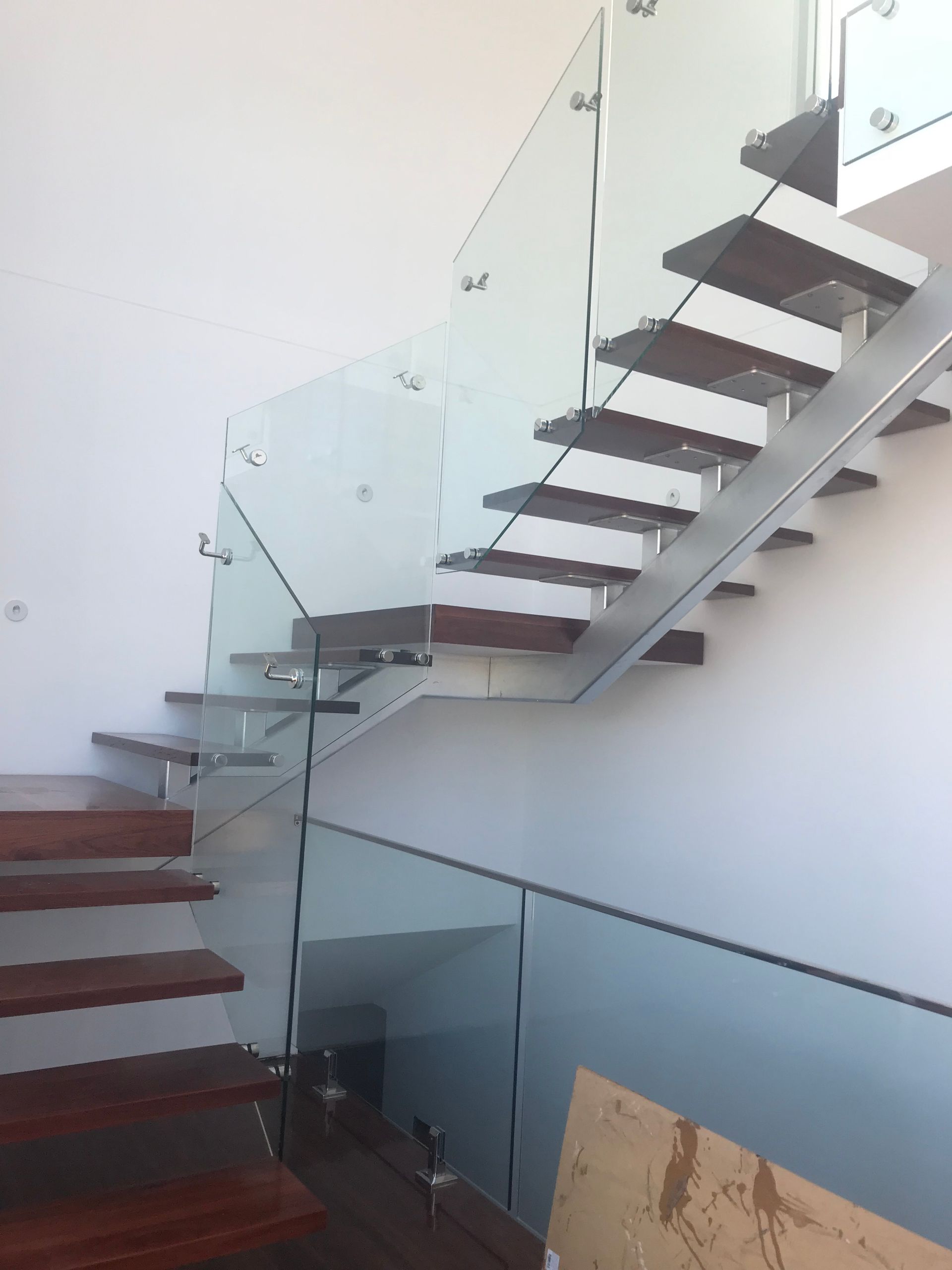 A staircase with a glass railing and wooden steps — Fabricator In Coffs Harbour, NSW