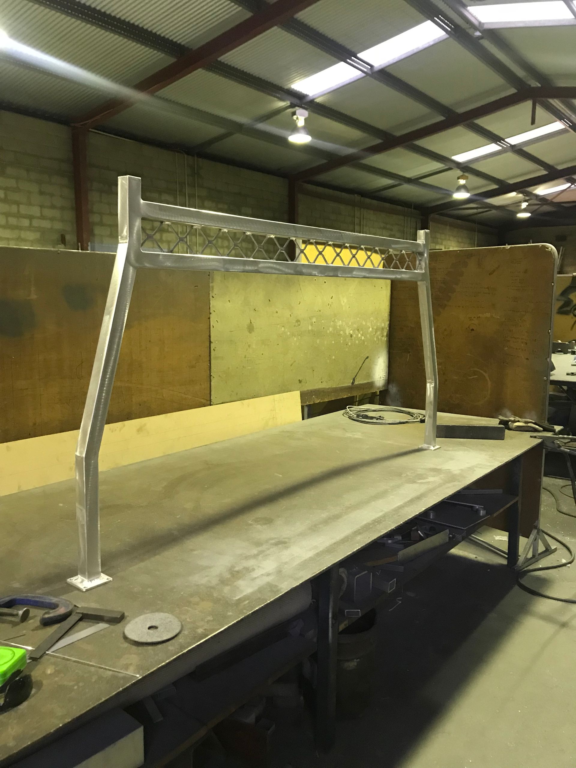 A metal structure is sitting on top of a table in a warehouse — Fabricator In Coffs Harbour, NSW