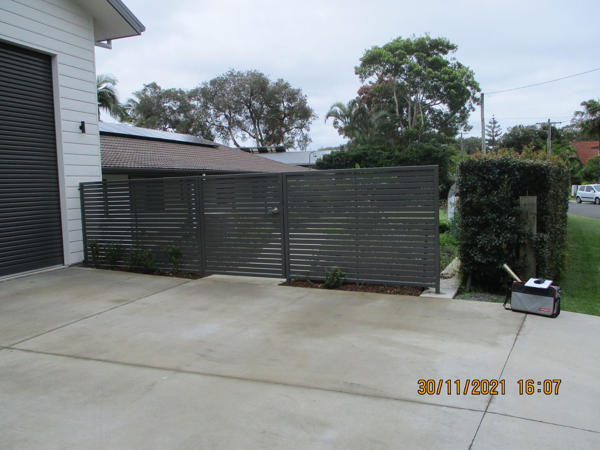 A driveway with a fence and a house in the background — Fabricator In Coffs Harbour, NSW