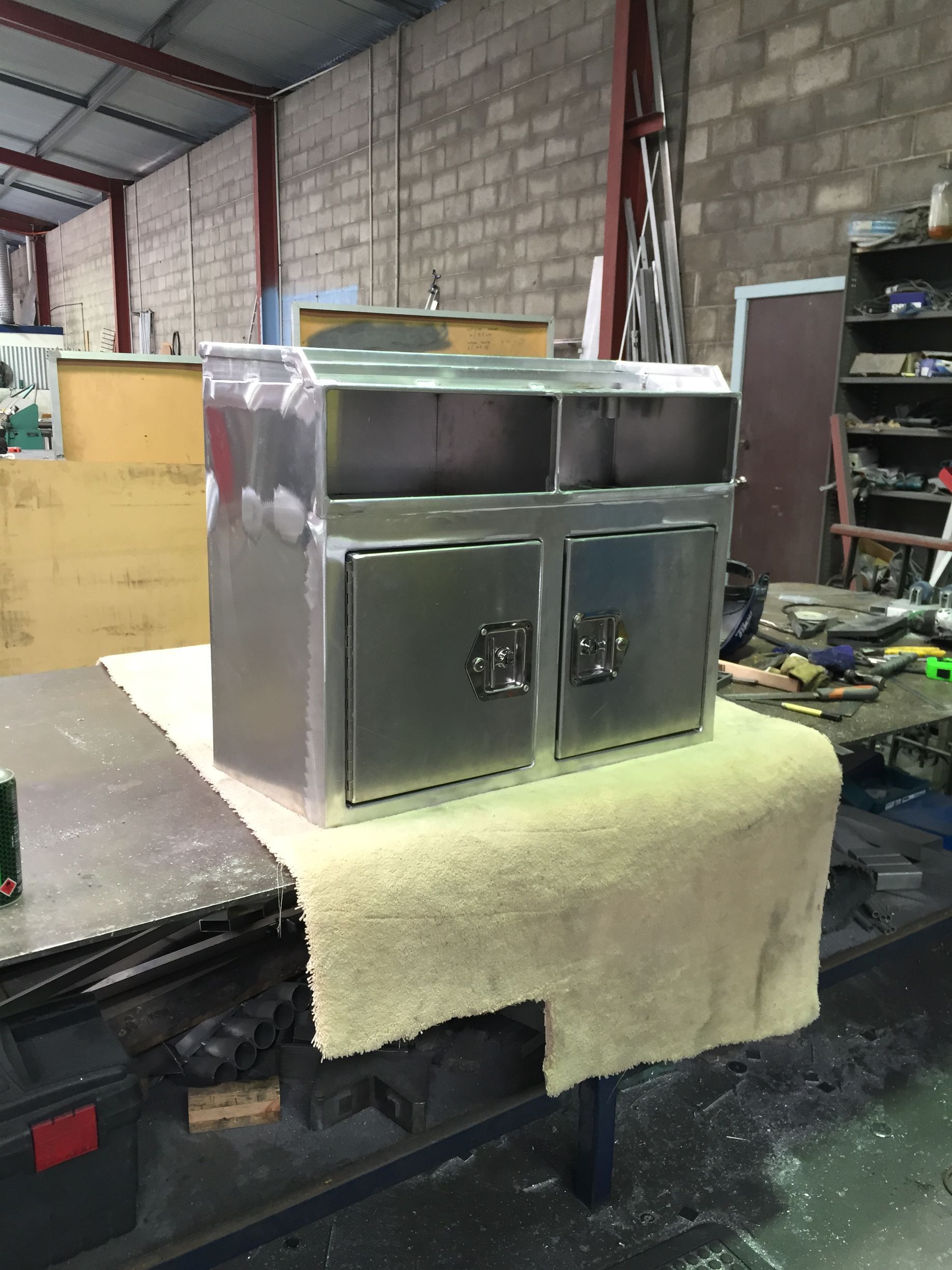 A stainless steel trash can is sitting on a table in a warehouse — Fabricator In Coffs Harbour, NSW