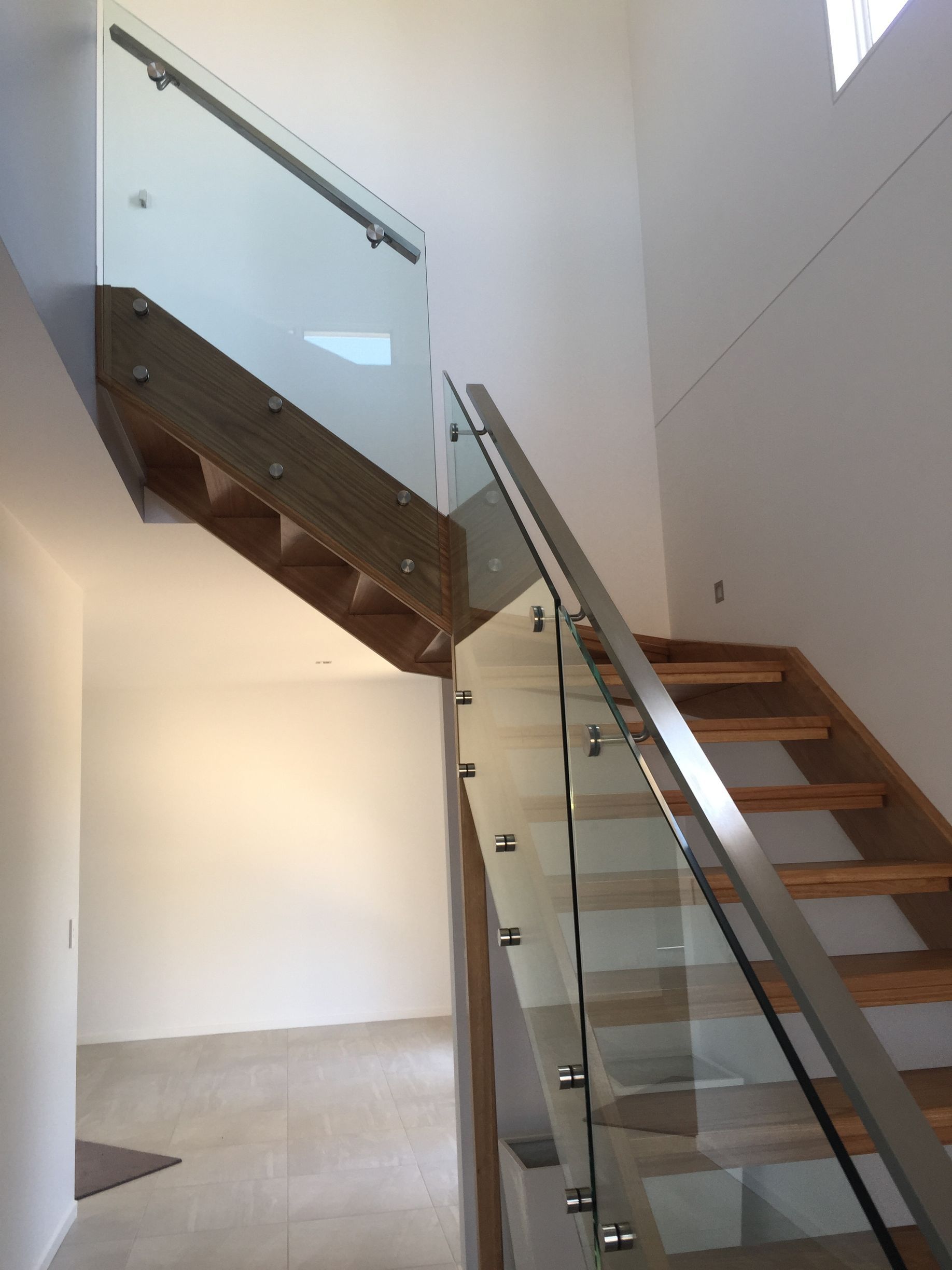 A staircase with a glass railing and wooden steps — Fabricator In Coffs Harbour, NSW