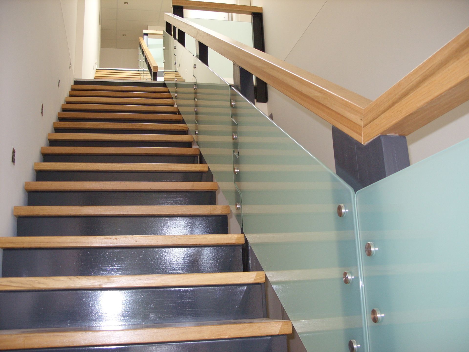 A set of stairs with wooden steps and a glass railing — Fabricator In Coffs Harbour, NSW