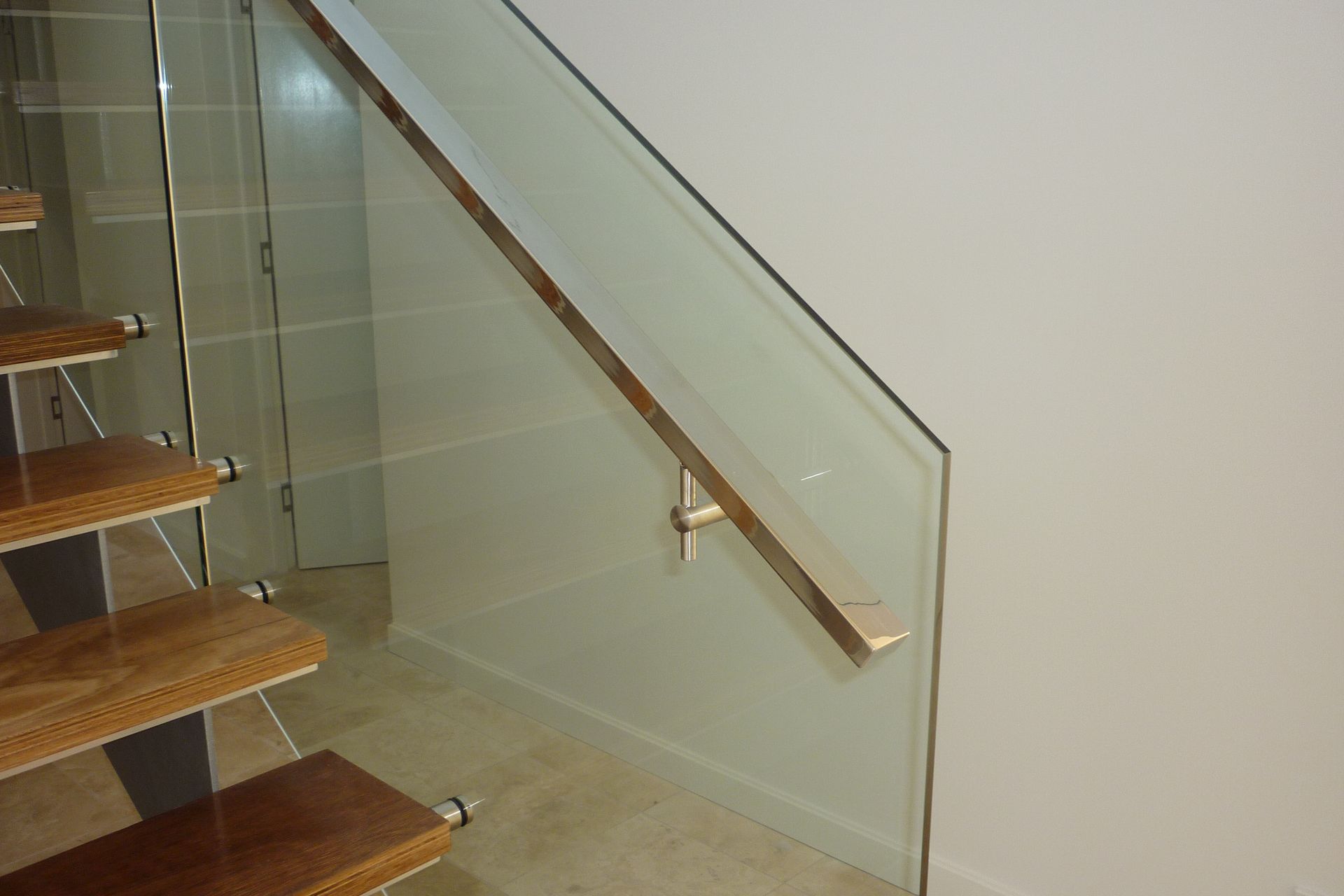 A staircase with a glass railing and wooden steps — Fabricator In Coffs Harbour, NSW