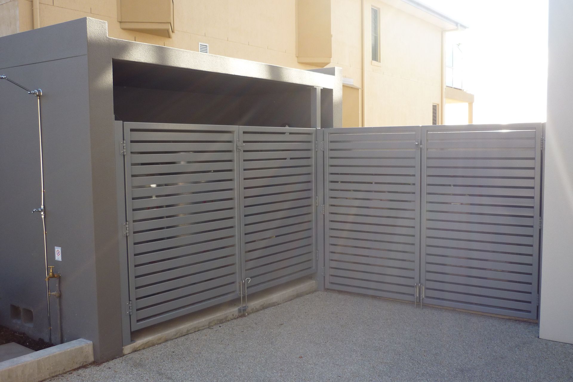 A gray fence is surrounding a gray building — Fabricator In Coffs Harbour, NSW