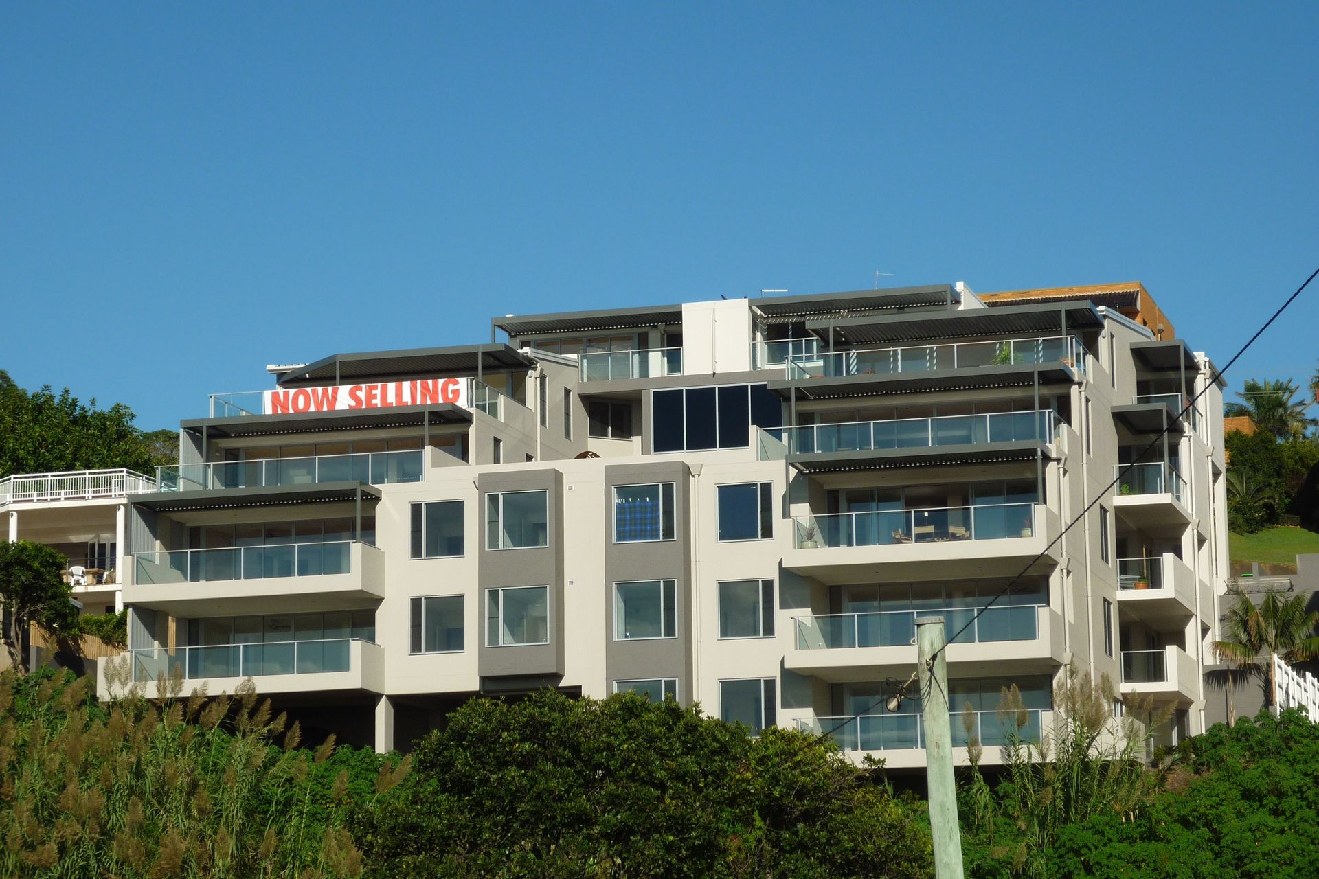 A large apartment building with a red sign that says ' king ' on it — Fabricator In Coffs Harbour, NSW