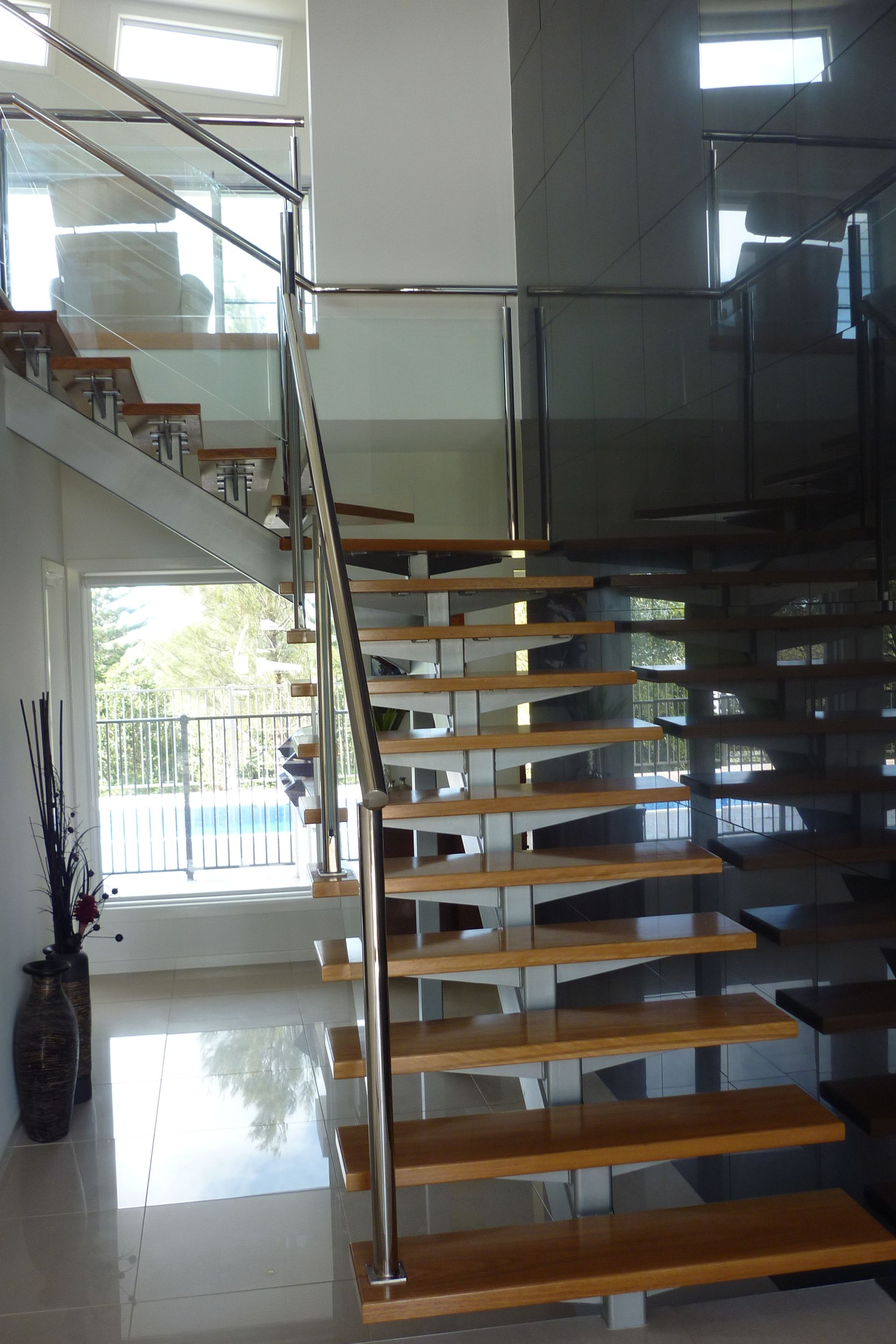 A staircase with wooden steps and a glass railing — Fabricator In Coffs Harbour, NSW