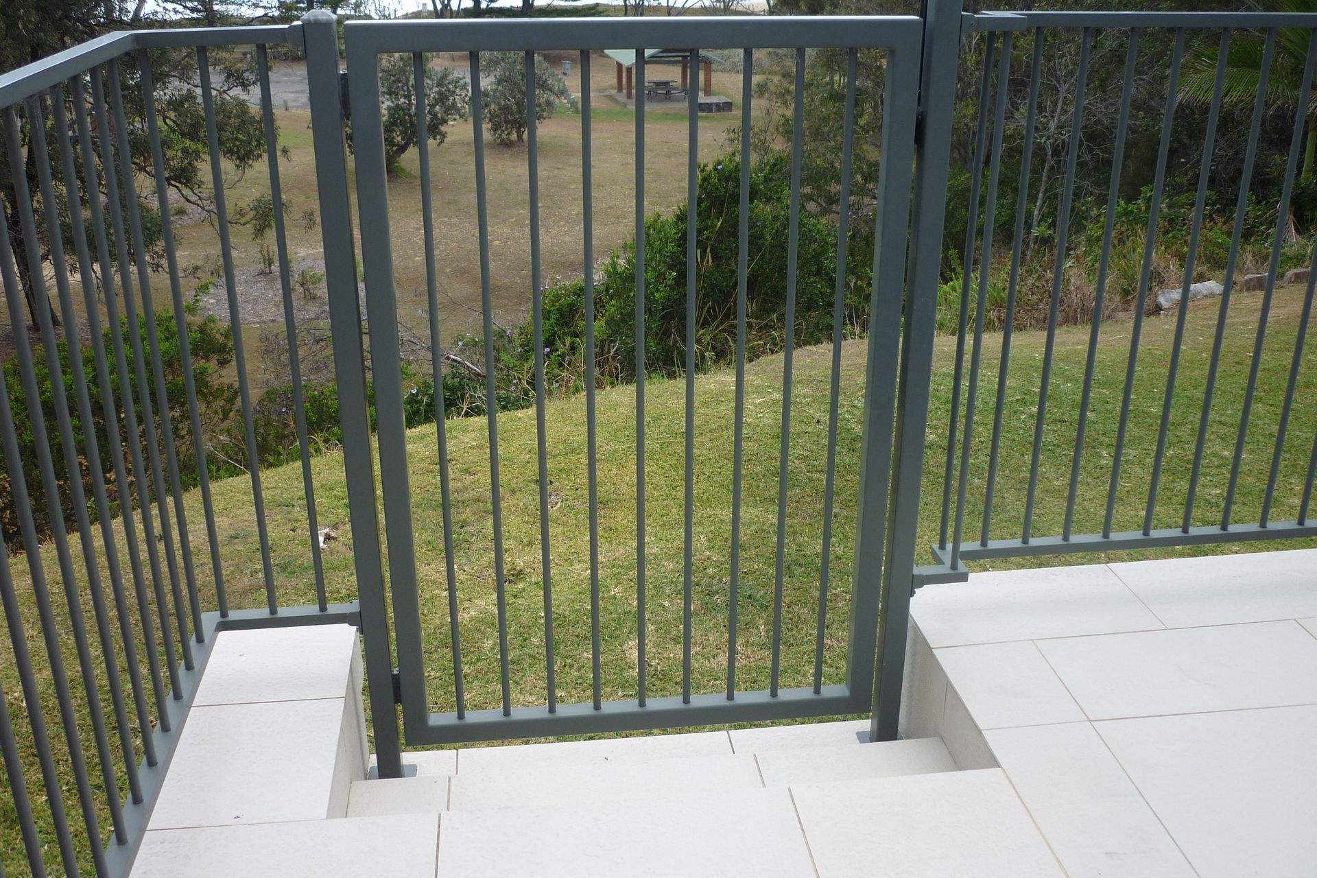 A fence with a gate leading to a grassy area — Fabricator In Coffs Harbour, NSW