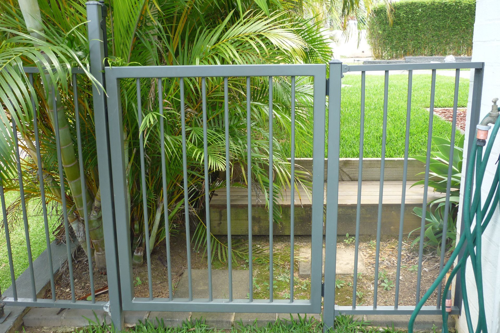 A metal gate with a hose attached to it — Fabricator In Coffs Harbour, NSW