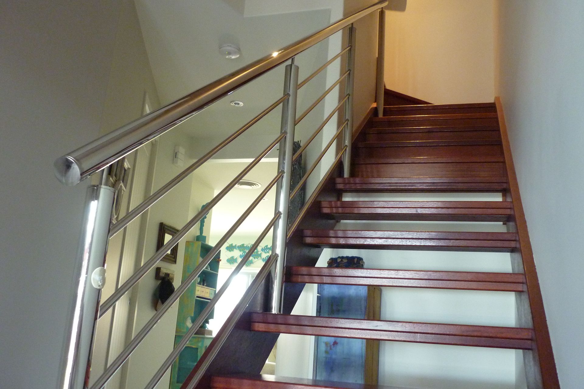 A wooden staircase with a stainless steel railing — Fabricator In Coffs Harbour, NSW