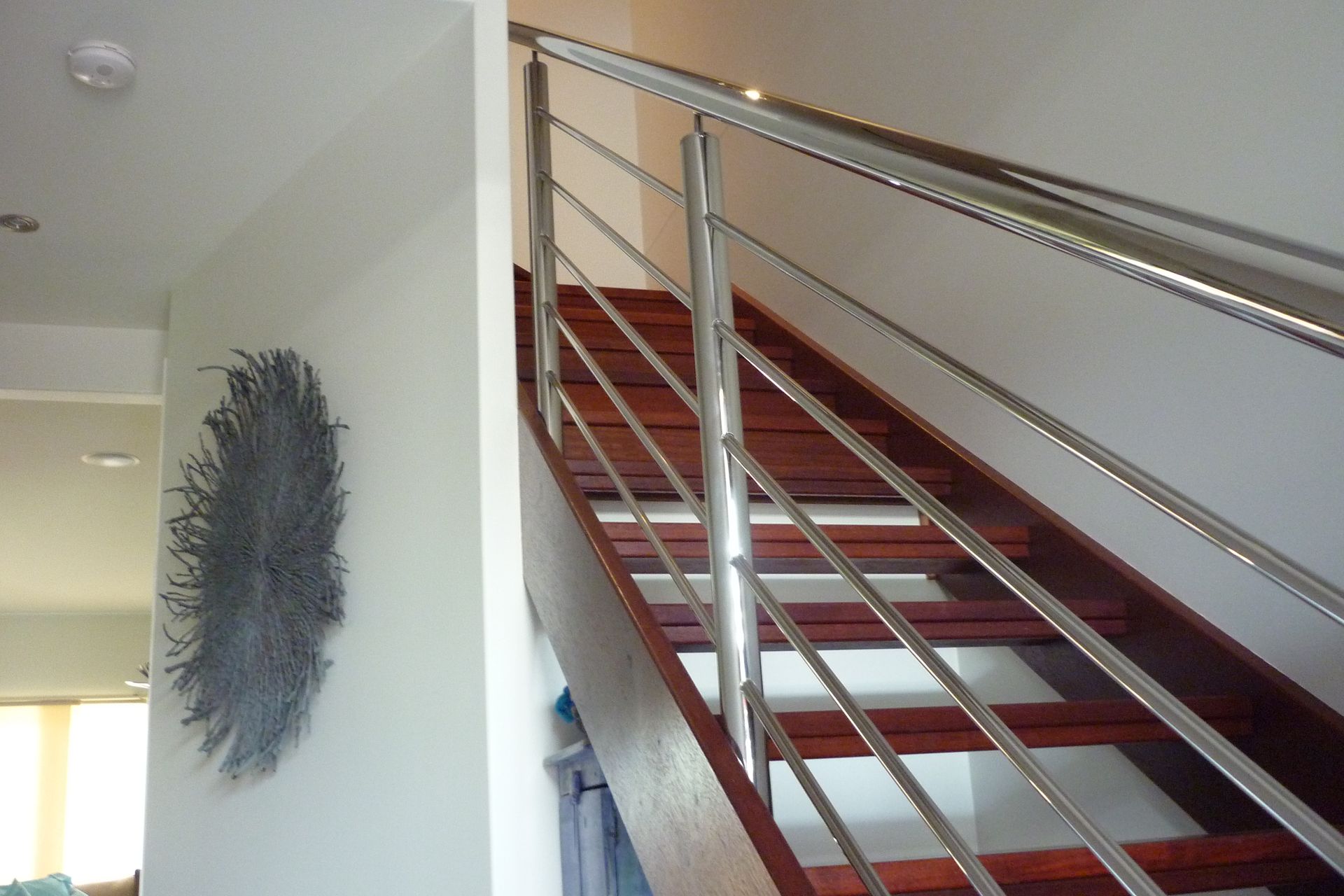 A wooden staircase with a stainless steel railing — Fabricator In Coffs Harbour, NSW
