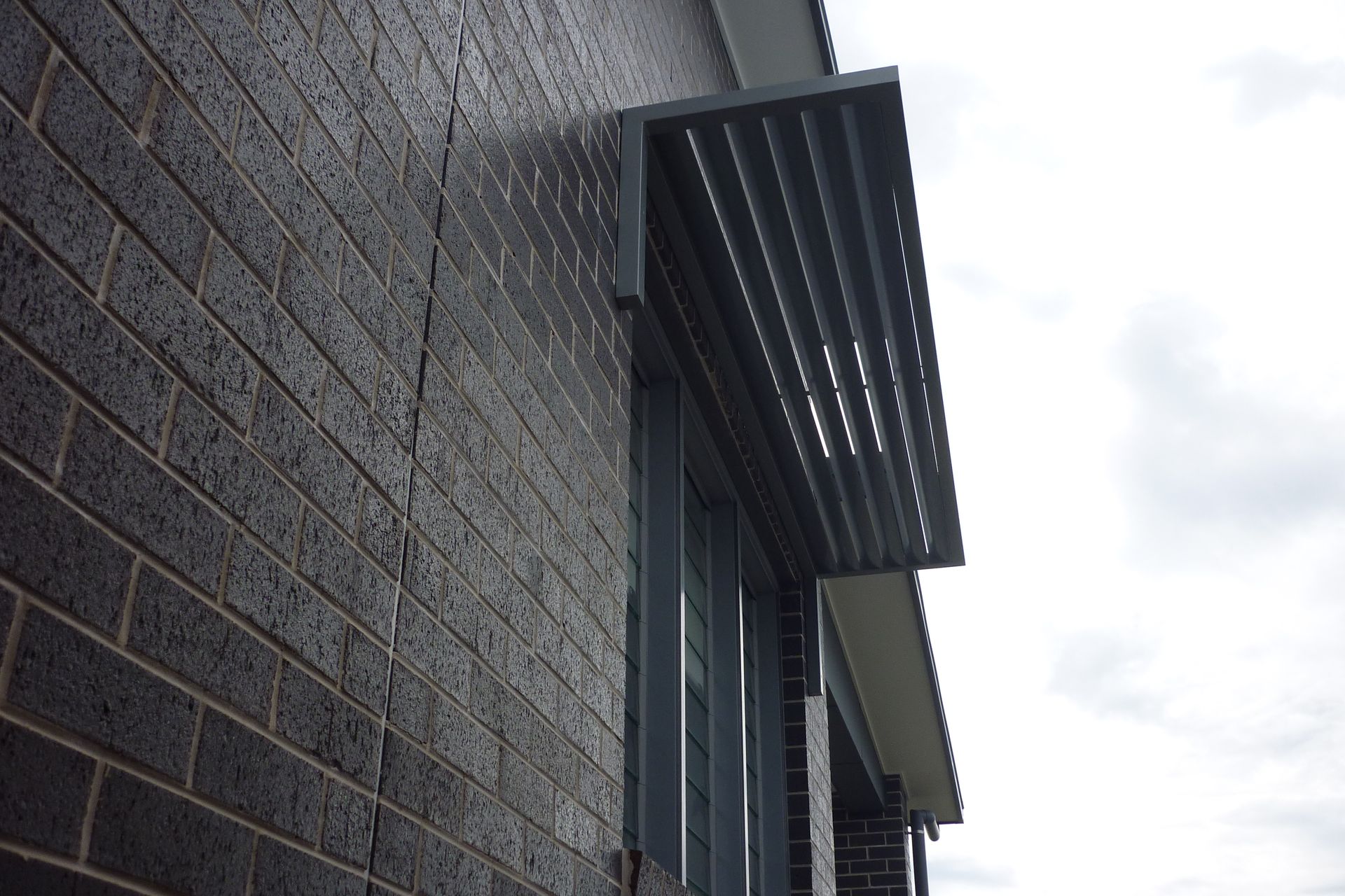 A brick building with a gray awning over a window — Fabricator In Coffs Harbour, NSW