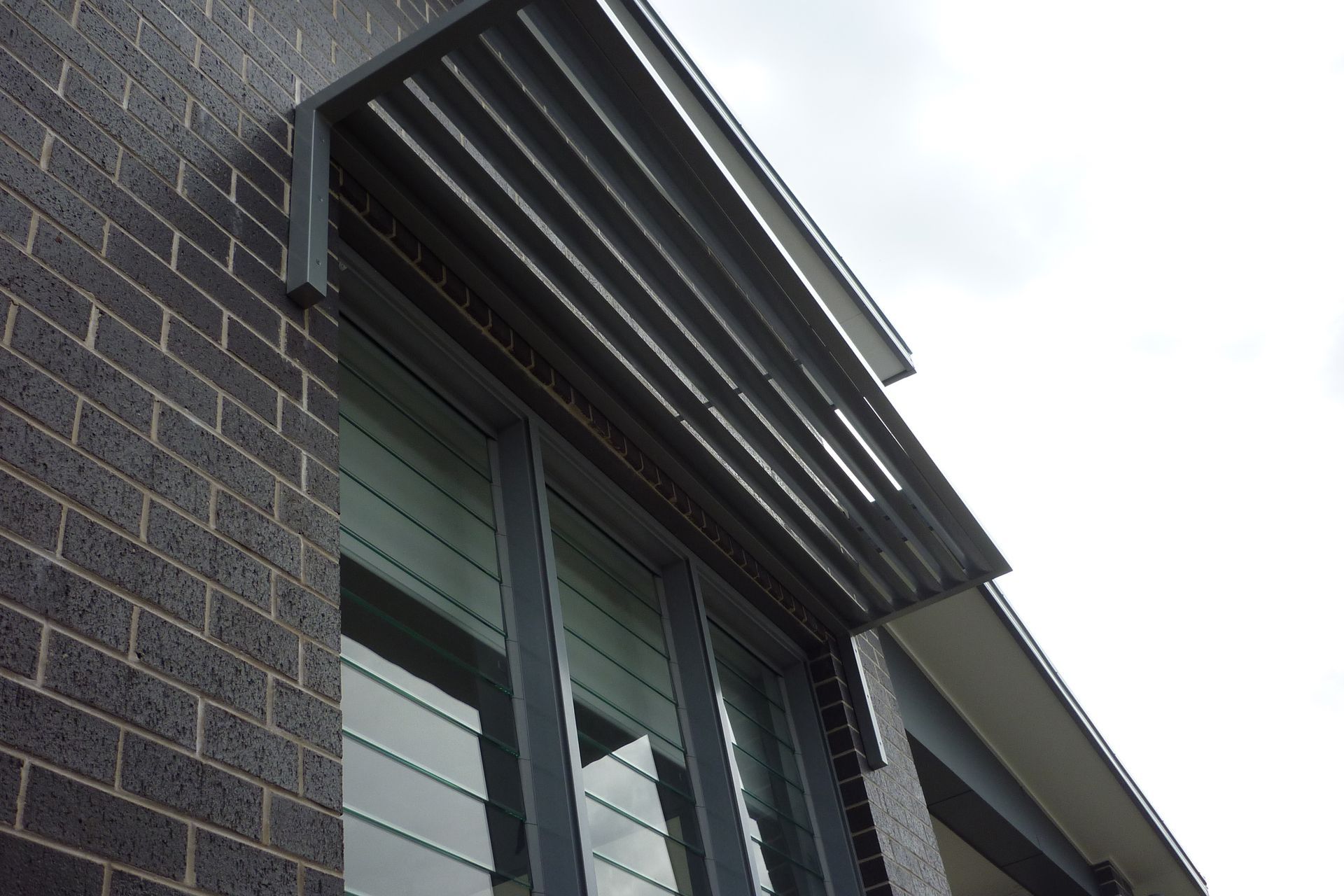 A brick building with a gray awning over a window — Fabricator In Coffs Harbour, NSW