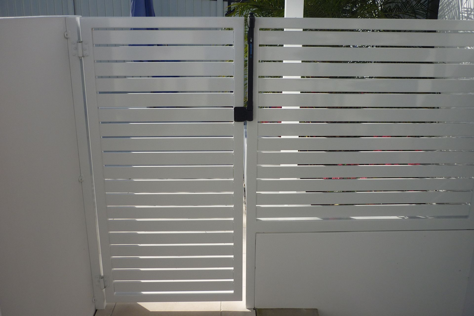 A white fence with a gate in the middle of it — Fabricator In Coffs Harbour, NSW