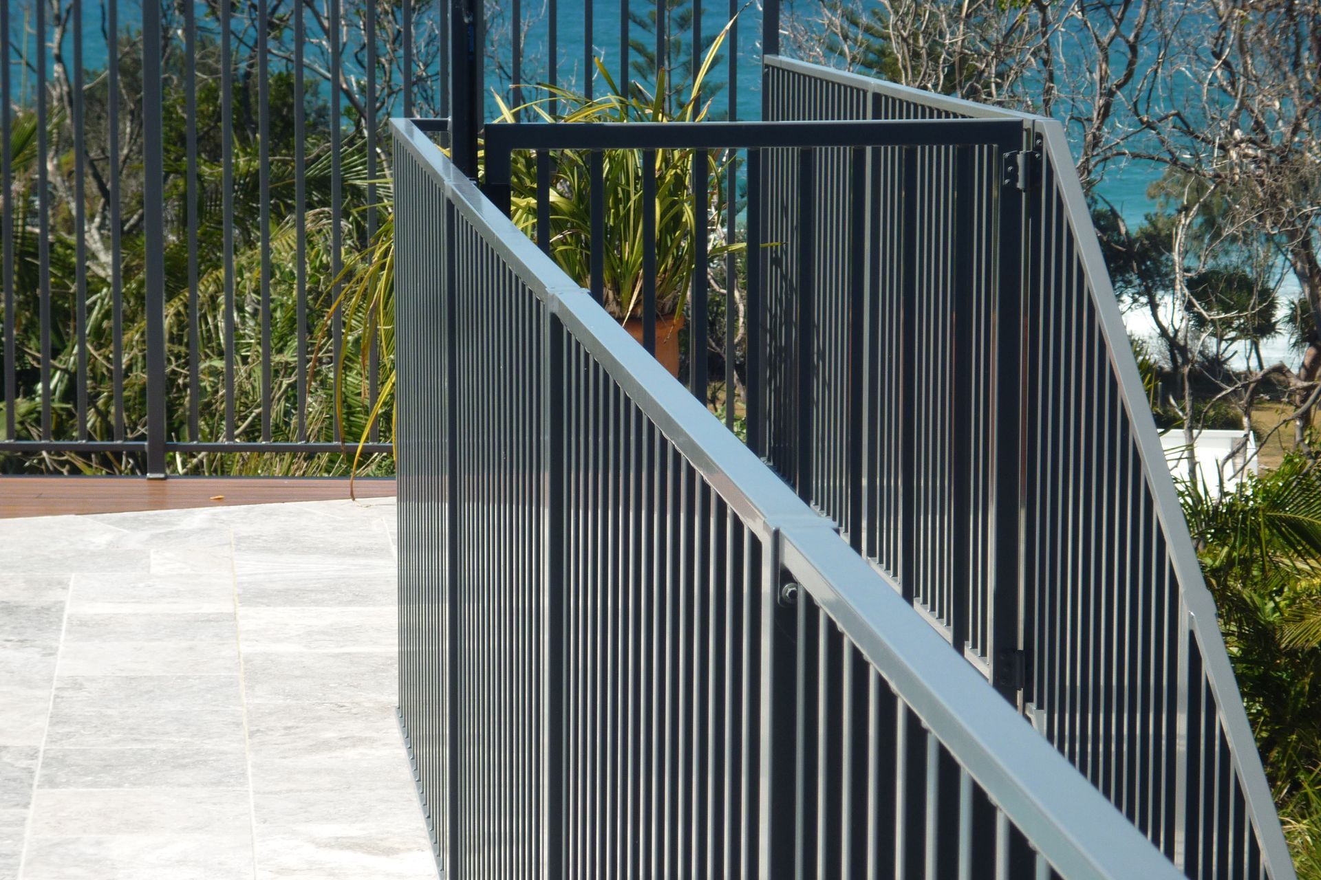 A staircase with a metal railing and a view of the ocean — Fabricator In Coffs Harbour, NSW