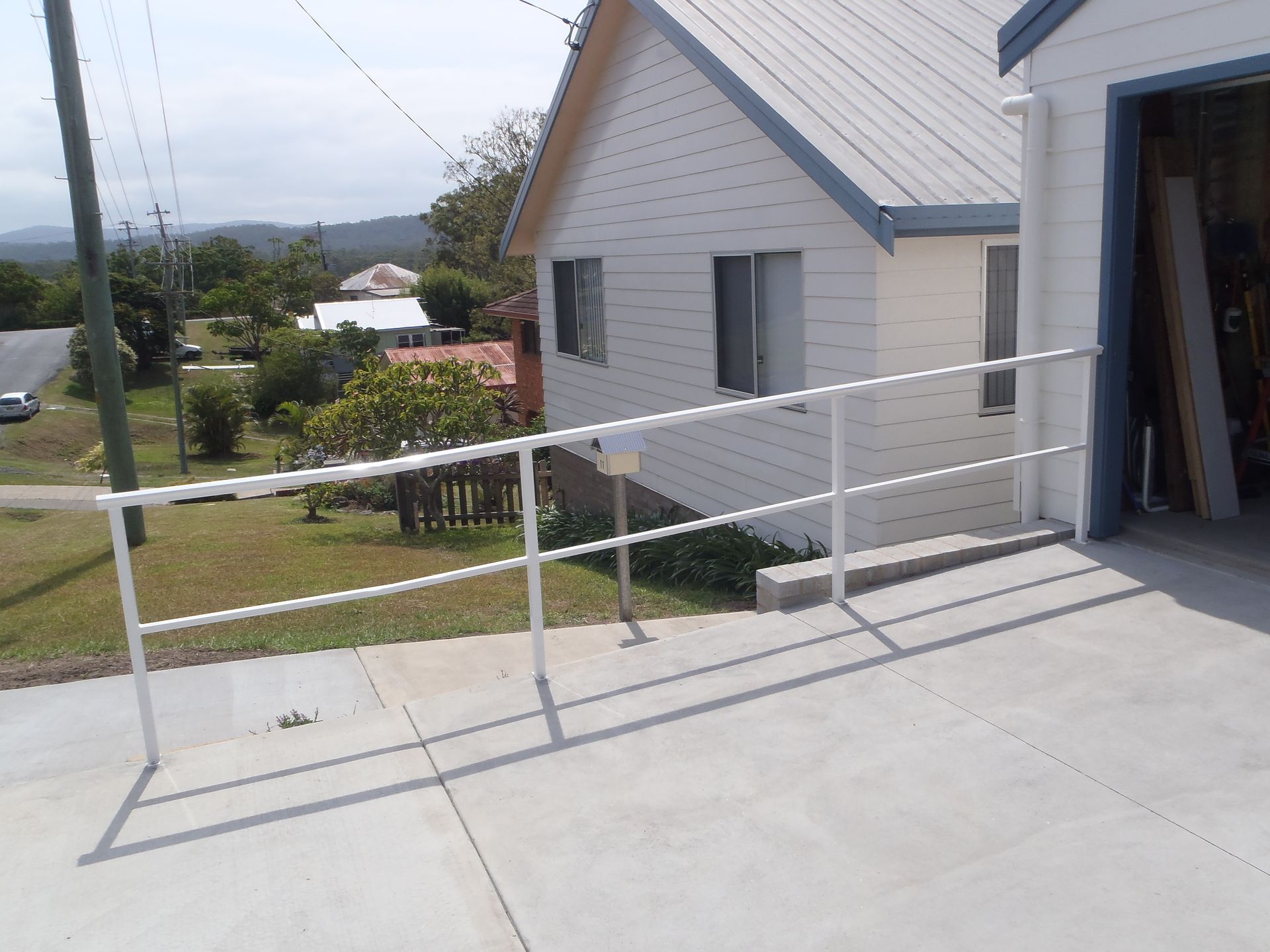 A white house with a white railing in front of it — Fabricator In Coffs Harbour, NSW