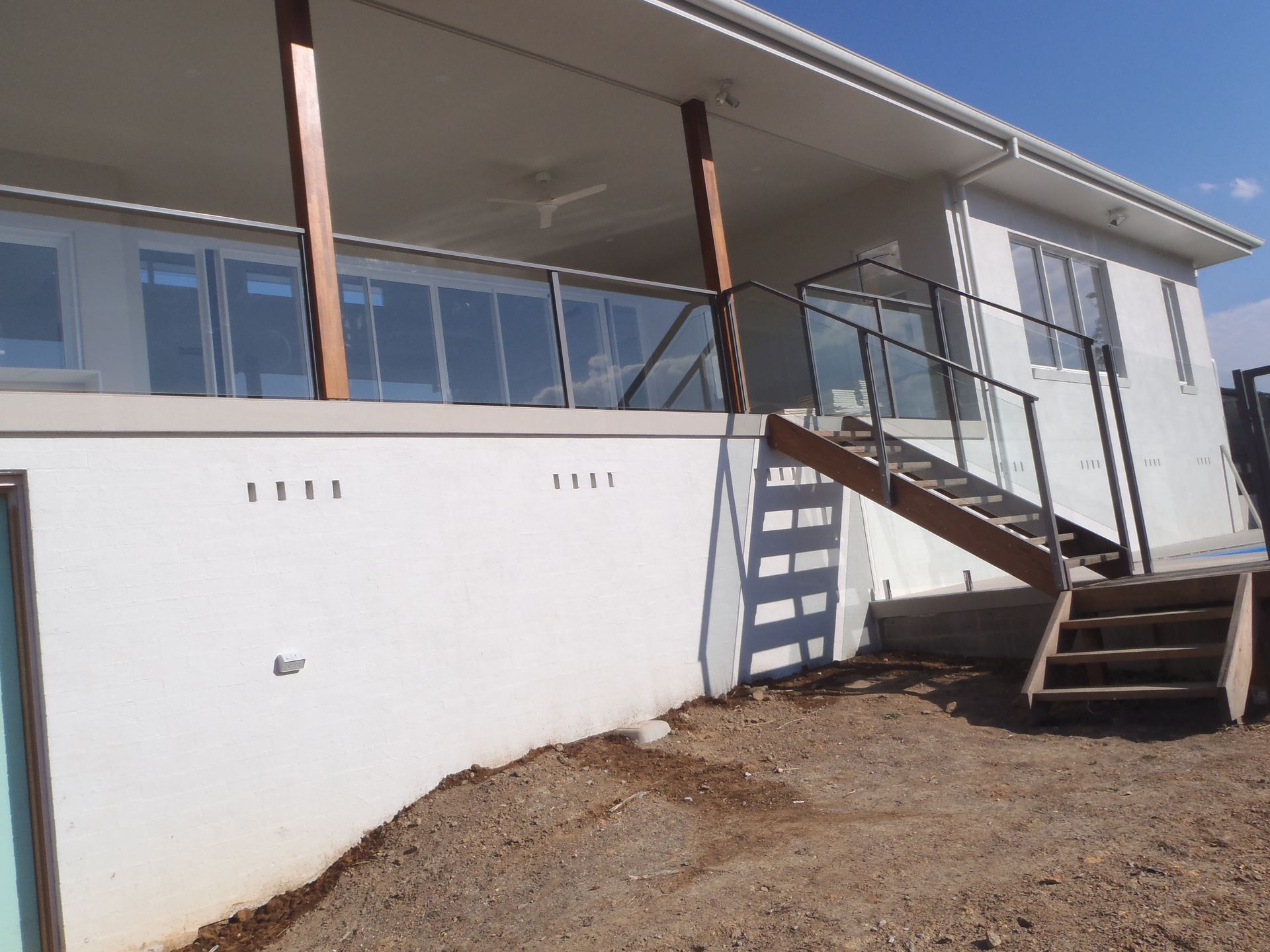 A white house with stairs leading up to it — Fabricator In Coffs Harbour, NSW