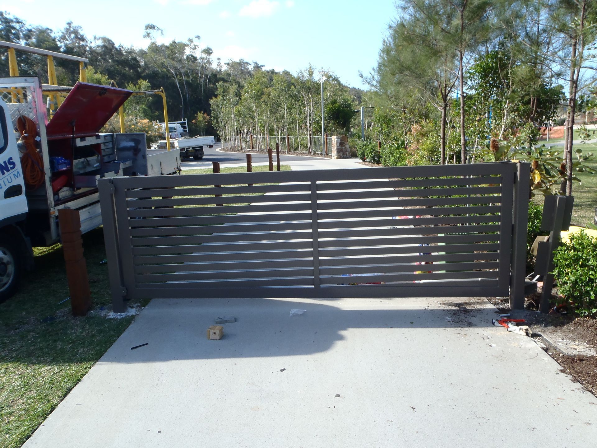A white truck is parked next to a sliding gate — Fabricator In Coffs Harbour, NSW