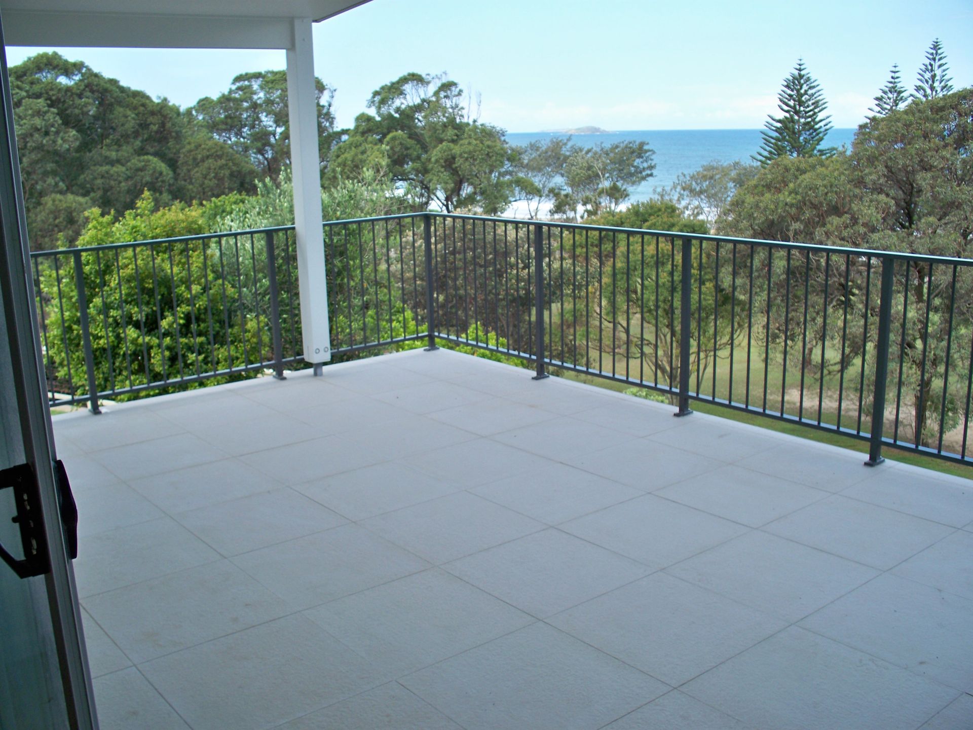 A balcony with a view of the ocean and trees — Fabricator In Coffs Harbour, NSW