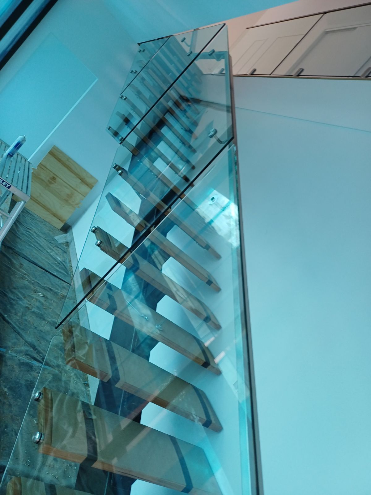 A staircase with a glass railing and wooden steps — Fabricator In Coffs Harbour, NSW