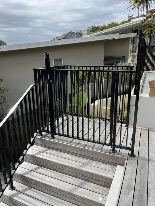 A black metal fabricated pool fence.