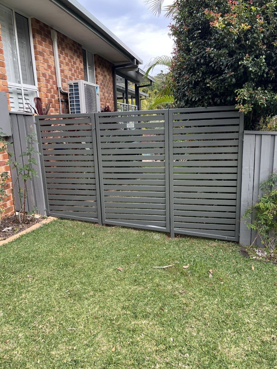 There is a fence in the backyard of a house — Fabricator In Coffs Harbour, NSW