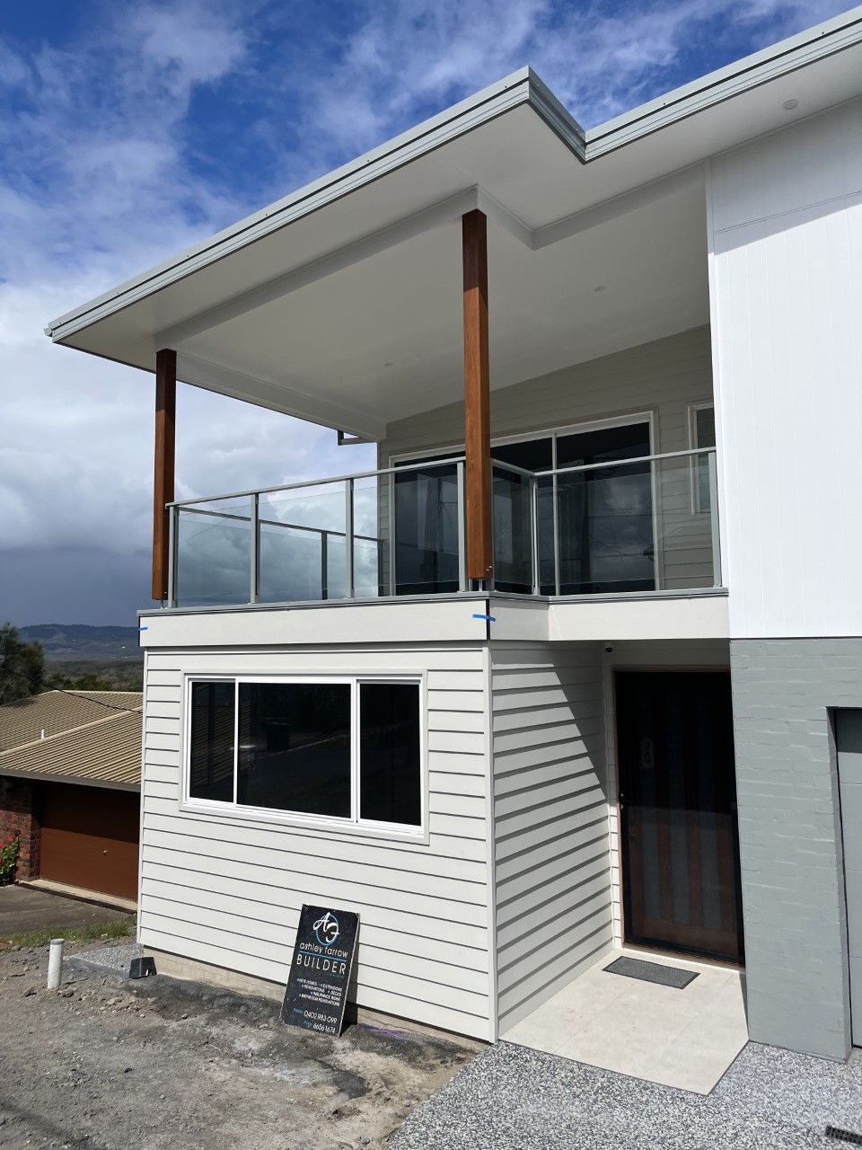 A white house with a balcony and a sign that says ' a ' on it — Fabricator In Coffs Harbour, NSW