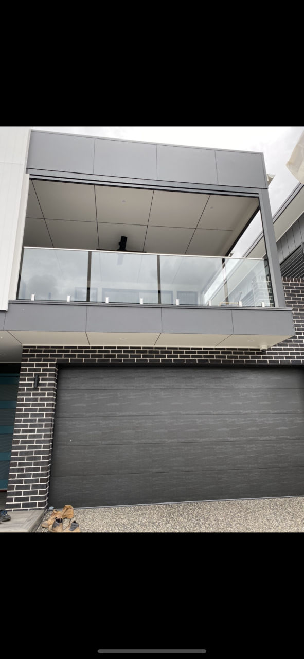 A large house with a balcony and a garage door — Fabricator In Coffs Harbour, NSW
