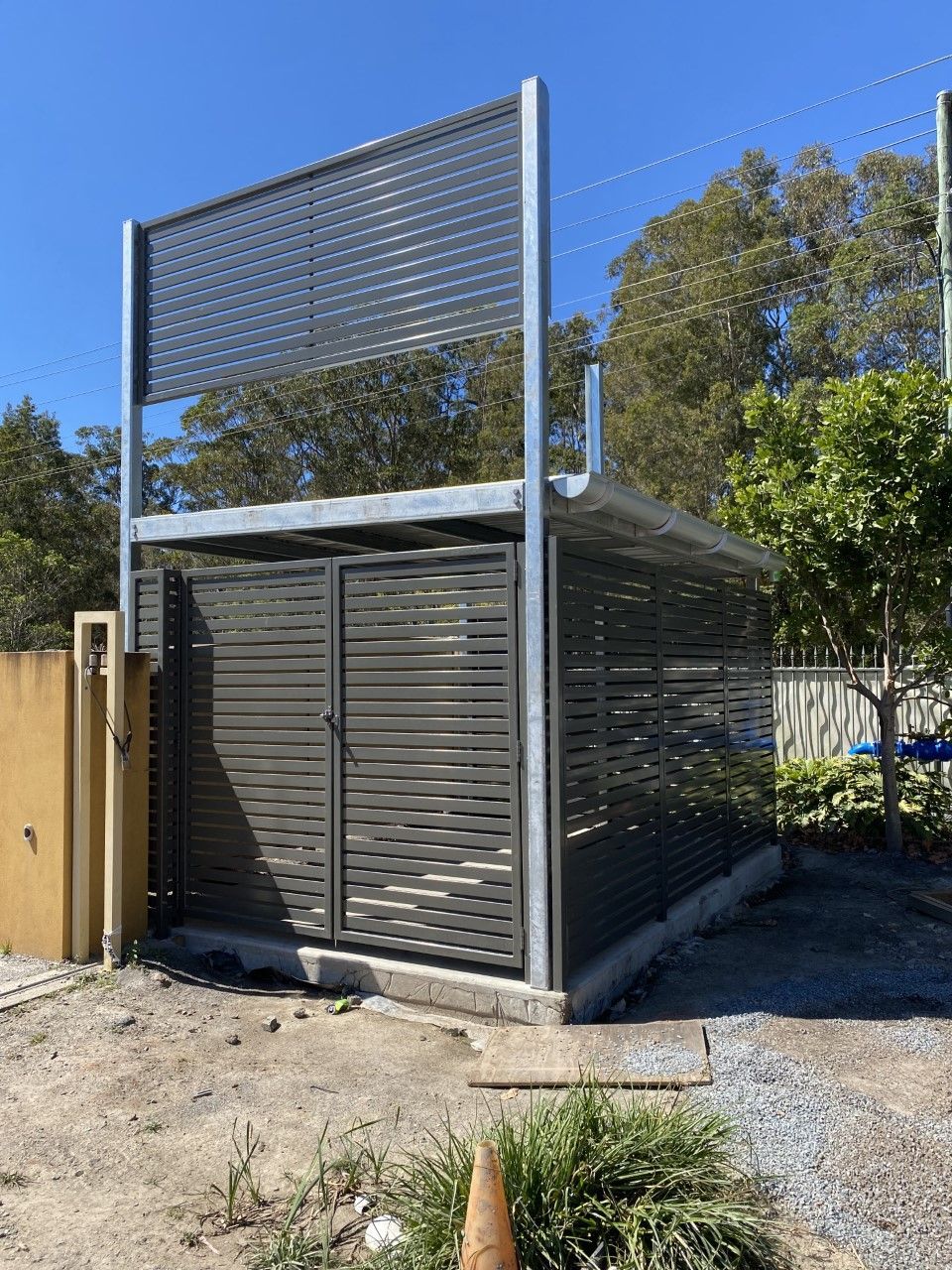 A metal fence is sitting in the middle of a dirt field — Fabricator In Coffs Harbour, NSW