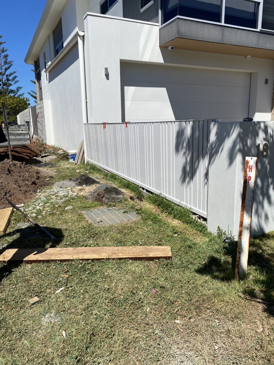 A white house with a white fence in front of it — Fabricator In Coffs Harbour, NSW