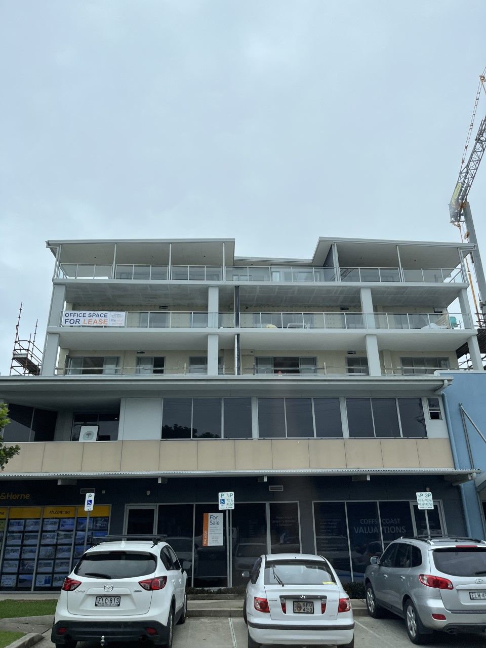 A large building with cars parked in front of it — Fabricator In Coffs Harbour, NSW