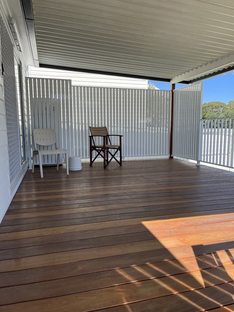 A wooden deck with a chair and a table on it — Fabricator In Coffs Harbour, NSW