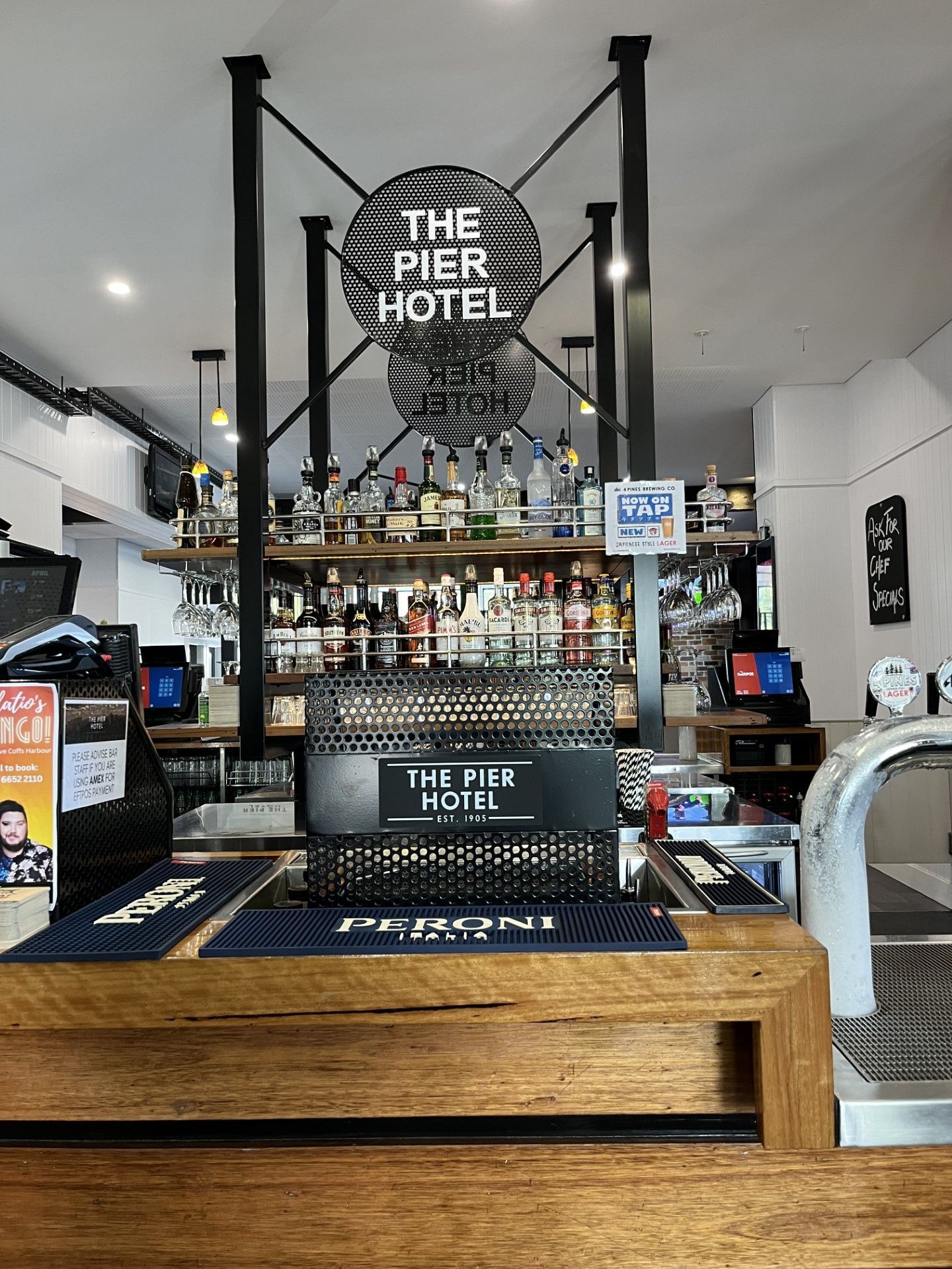 A restaurant with a bar and a sign that says the pier hotel — Fabricator In Coffs Harbour, NSW