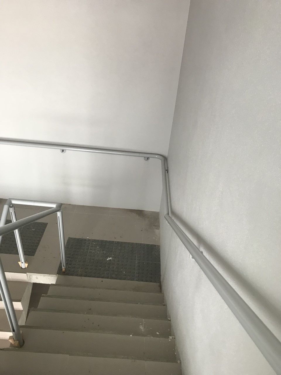 A staircase with a metal railing and a white wall — Fabricator In Coffs Harbour, NSW