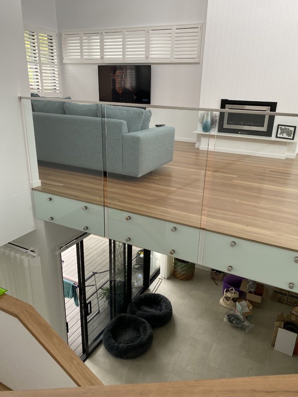 A living room with a couch , chair , television and fireplace — Fabricator In Coffs Harbour, NSW