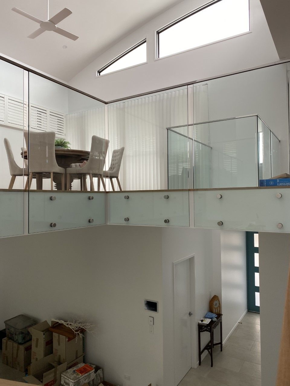 A dining room with a glass railing and a ceiling fan — Fabricator In Coffs Harbour, NSW