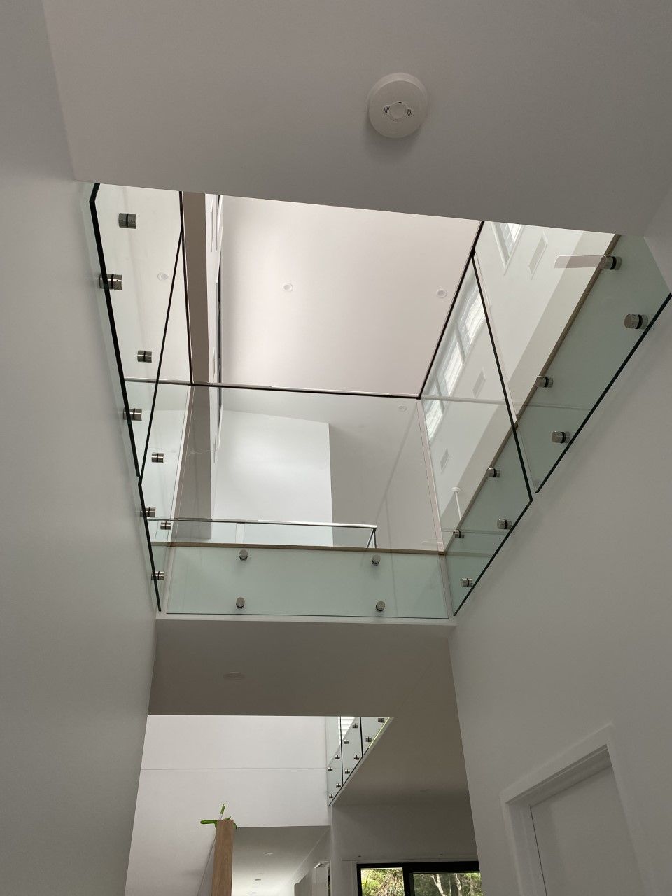 Looking up at a staircase with a glass railing — Fabricator In Coffs Harbour, NSW