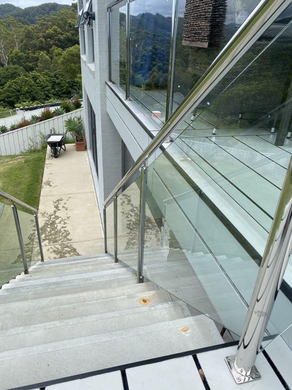 A set of stairs leading up to a balcony with a glass railing — Fabricator In Coffs Harbour, NSW