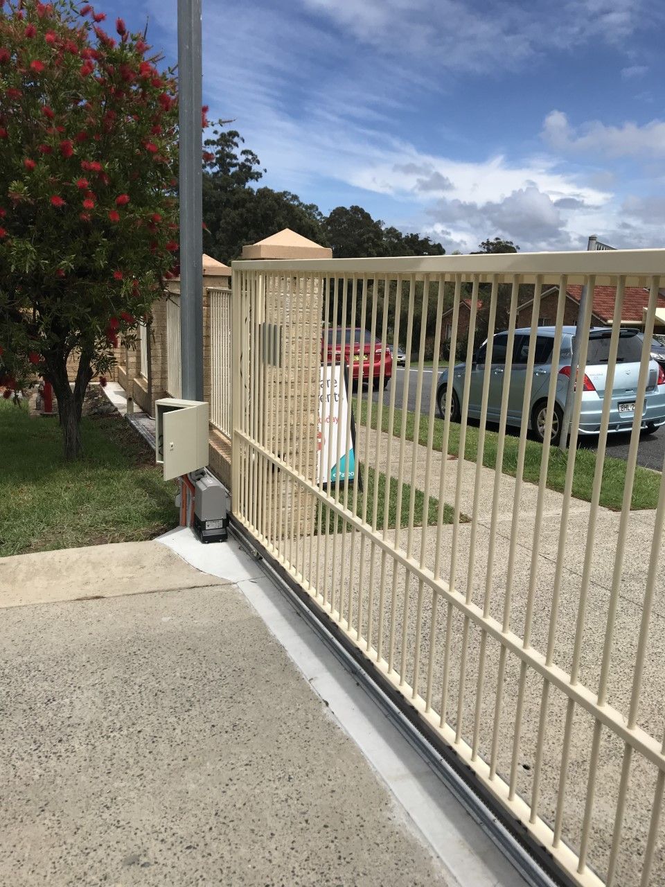 A sliding gate with cars parked behind it — Fabricator In Coffs Harbour, NSW