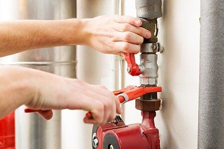 Plumber Working with Pipeline Connections — Pipe Leak Detection in Austin TX