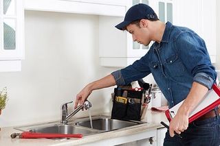 Plumber Inspecting Kitchen Faucet — Residential/Commercial Plumbing Repair Contractor in Austin TX