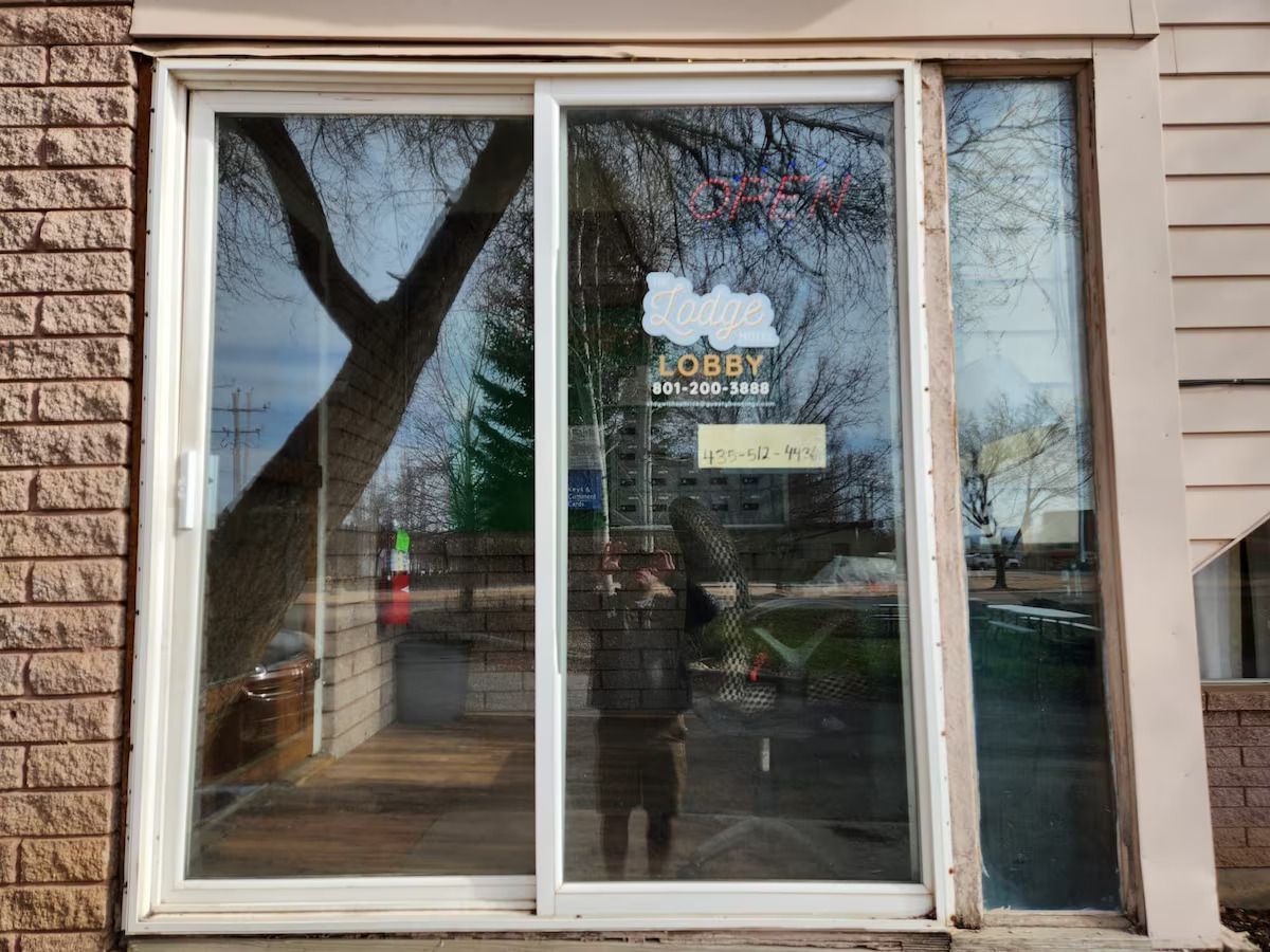 A sliding glass door with a lobby sign on it
