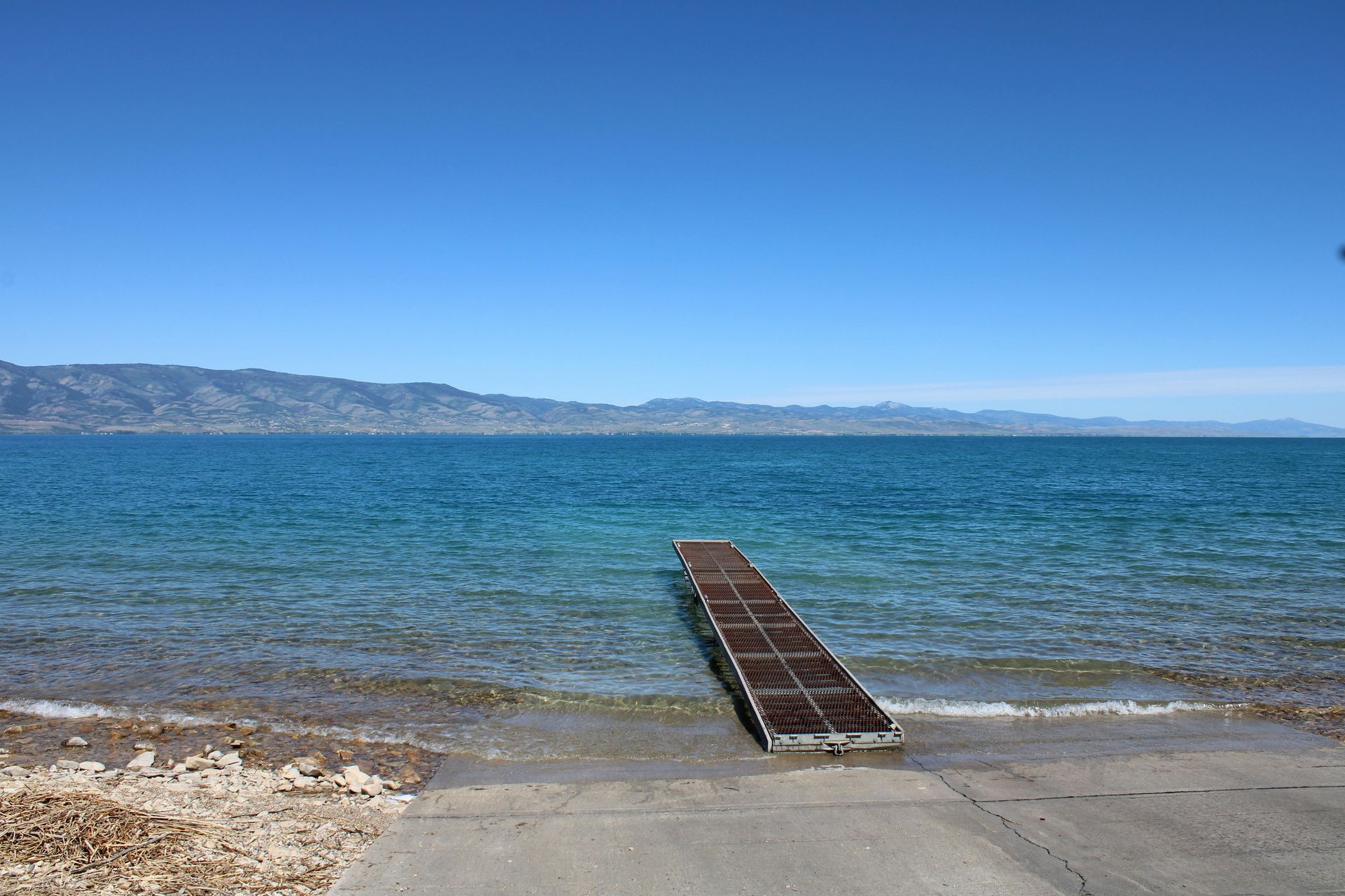 There is a dock in the middle of the ocean.